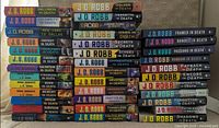Front spines of all 37 books stacked showing variety of titles and formats