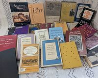 Overhead view of 25 assorted play books spread out, showing front covers and variety of titles
