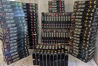 Front and spine view of large group of Star Trek: TNG VHS tapes arranged in stacks