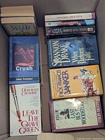 Top view showing several identified paperbacks in box