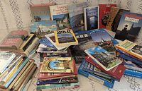 Overview of entire lot of stacked and spread travel books