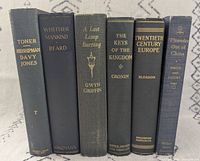 Spine view of all six vintage dark hardcovers