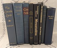 Front spines of all eight books showing titles and authors