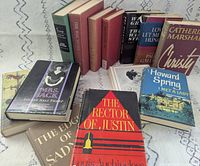Group shot of all 13 books standing and lying to show covers and spines
