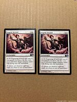 Both Angelic Accord cards side by side on cardboard background