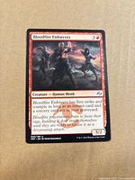 Front of Bloodfire Enforcers card showing title, mana cost, type line, text box, power/toughness, collector number 098/185, artist credit Yefim Kagan