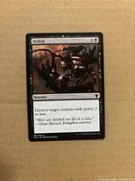 Front view of Defeat card showing artwork, mana cost, text