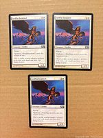 Three Griffin Sentinel cards laid out on cardboard background