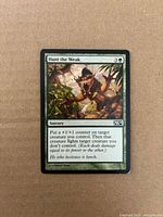 Front of Hunt the Weak card showing artwork, title, mana cost, text box, set symbol