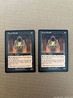 Both Necra Disciple cards side by side