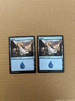 Both Island cards front view on cardboard background