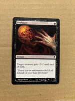 Front of Disfigure card showing name, art, rules text and visible edgewear