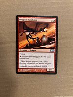 Front of Dragon Hatchling card showing name, mana cost, artwork, and set symbol