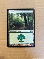 Front of Forest basic land card showing artwork and set symbol