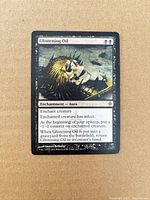 Front of Glistening Oil card showing artwork, text, wear