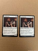 Front view of both Inspiring Cleric cards