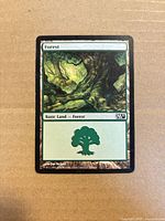 Front of Forest basic land card showing artwork and set symbol