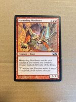 Front of Marauding Maulhorn card showing artwork, text, set symbol M14