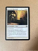 Front of Security Blockade card showing art, mana cost, text, and visible wear