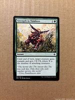 Front of Strength in Numbers card showing artwork, text, collector number 191/221
