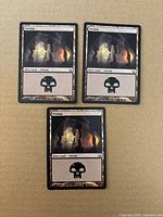Fronts of all three Swamp cards displayed