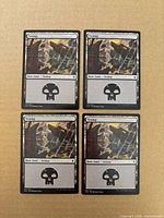 Front view of all four Swamp cards