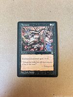 Front of Torment card showing artwork, mana cost, text box, and condition