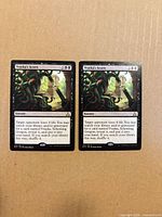Fronts of both Vraska's Scorn cards