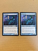 Front view of both Merfolk Spy cards