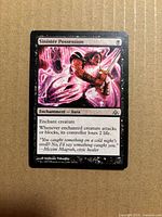 Front of Sinister Possession card showing artwork, title, type line, and condition wear