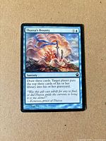 Front of Thassa's Bounty card showing artwork, mana cost and text