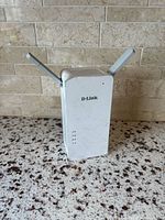 Front view showing D-Link logo, status LEDs, folded antennas