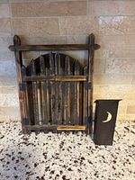 Front view showing gate panel closed beside metal lantern