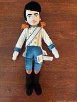 Front view of Prince Eric plush showing attire and facial features