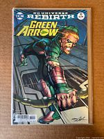 Front cover of Green Arrow #10 in protective bag on cardboard background