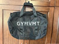 Front view showing logo, handles, exterior pocket, overall condition