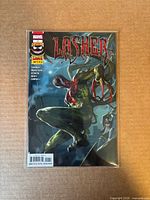 Front view of Lasher #1 comic in bag with board