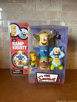 Front view of sealed Kamp Krusty figure set in packaging