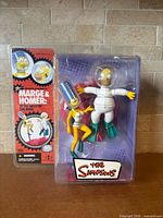Front view of factory-sealed Marge & Homer action figure set in blister pack