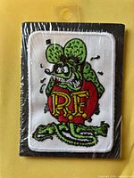 Front view of sealed Rat Fink patch showing full design