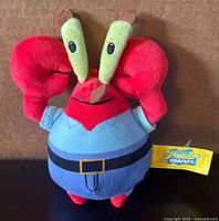 Front view of Mr. Krabs plush showing colors, face, tag