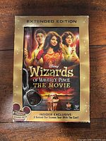 Front of DVD case showing title, Extended Edition label, and pendant keychain in blister