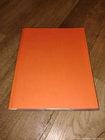 Closed orange binder front view