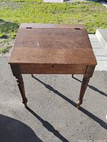 Full view of desk showing top surface, hinges, legs