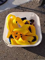 Plastic bin filled with yellow webbing straps