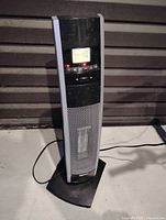 Full view of Bionaire tower heater showing digital display, grille, cord and base