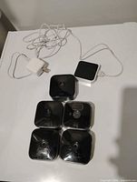 Five Blink cameras, sync module and AC adapter overview