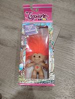 Front view of boxed Treasure Troll showing figure, hair, and wishstone