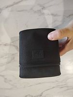 Sigma EX zip lens pouch held in hand