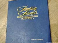Blue binder front cover with gold Fantasy Friends logo and personalized name